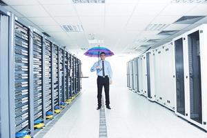 businessman hold umbrella in server room photo