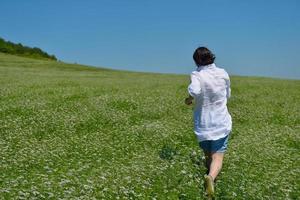 Young happy woman in green field photo