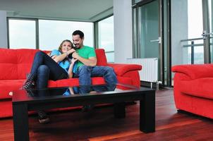 happy couple relax on red sofa photo