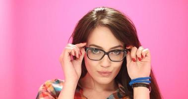 woman smiling wearing on a pair of large glasses photo