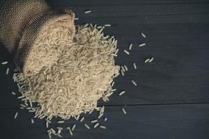 Sheaf yellow rice and white rice and organic jasmine rice on wooden table photo