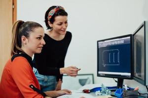 Within the heavy industry, a factory industrial engineer measures with a caliper and on a personal computer Designs a 3D model photo