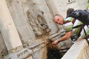 Tourist getting water photo