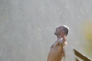 Man in waterfall photo