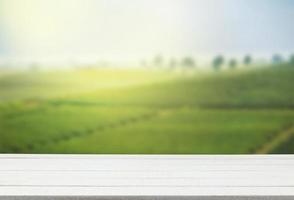 Empty wooden table with view of mountain or wooden desk with plantation nature with bokeh background, copy space for your text photo