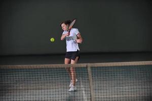 Playing tennis indoors photo