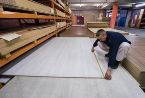 carpenter measuring wooden board photo