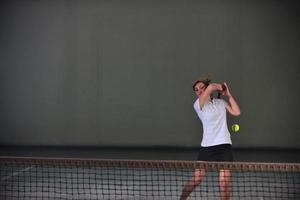 Playing tennis indoors photo