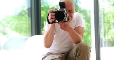 Photographer takes pictures with DSLR camera photo