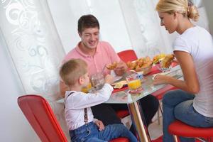 family have healthy breakfast at home photo