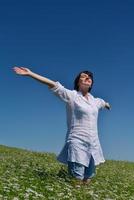 young woman in wheat field at summer photo