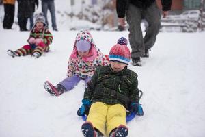 group of kids having fun and play together in fresh snow photo