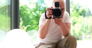 Photographer takes pictures with DSLR camera photo