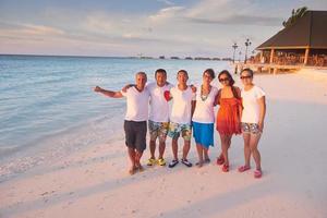 group of friends on beautiful beach photo