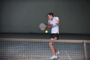 Playing tennis indoors photo