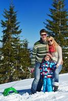 family having fun on fresh snow at winter photo