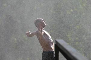 Man in waterfall photo