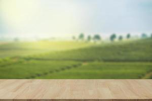 Empty wooden table with view of mountain or wooden desk with plantation nature with bokeh background, copy space for your text photo