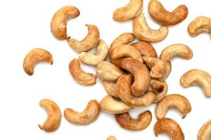 Roasted nuts in glass bowl isolated on white background photo