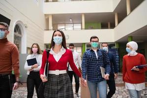 students group at university walking and wearing face mask photo