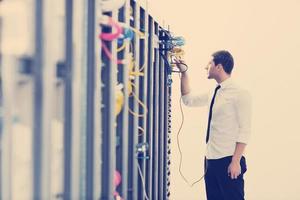 young it engeneer in datacenter server room photo