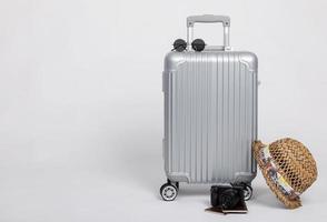 Travel Baggage with passport, camera, hat isolated on white background with copy space, Travel concept background photo