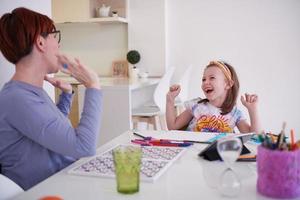 Mother and little daughter  playing together  drawing creative artwork photo