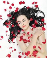 beautiful young nude woman with roses isolated on white photo