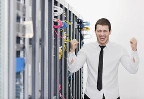 young it engeneer in datacenter server room photo