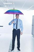 businessman hold umbrella in server room photo