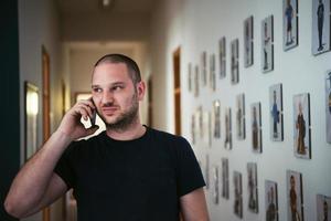 a portrait of a man in a work suit standing in the hallway of a factory photo