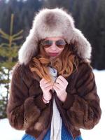 portrait of beautiful young redhair woman in snow scenery photo