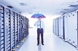 businessman hold umbrella in server room photo