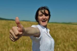 young woman in wheat field at summer photo