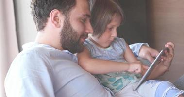Father Daughter using Tablet in modern apartment photo