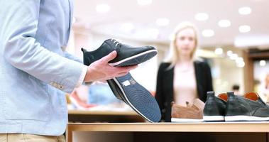 Man Chooses Shoes At Shoe Store photo