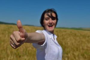 young woman in wheat field at summer photo