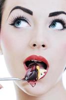 beautiful young woman eat sweet cake photo