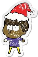 distressed sticker cartoon of a curious boy wearing santa hat vector