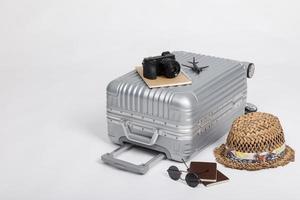 equipaje de viaje con pasaporte, cámara, sombrero, juguete de avión aislado en fondo blanco con espacio de copia, fondo de concepto de viaje foto