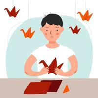 A man is sitting at the table and making a red crane out of paper. Boy makes origami. Vector flat illustration.