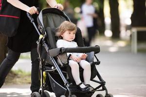 baby girl sitting in the pram photo