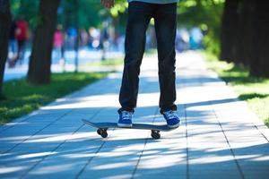 Skateboard jumping on sidewalk photo