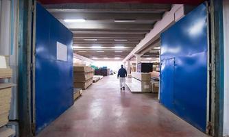 carpenter walking through factory photo