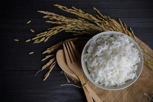 Japan rice with Thai jasmine rice and paddy rice seed on wooden table photo