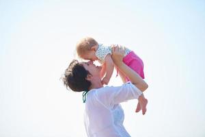 mom and baby on beach  have fun photo