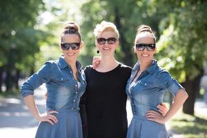 portrait of three young beautiful woman with sunglasses photo