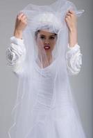 young bride in a wedding dress with a veil photo