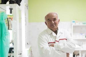 Mature veterinarian man or doctor in hospital clinic smiling happy and proud. photo