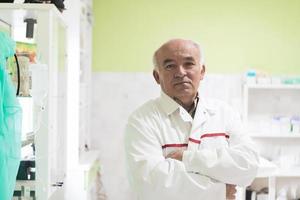 Mature veterinarian man or doctor in hospital clinic smiling happy and proud. photo